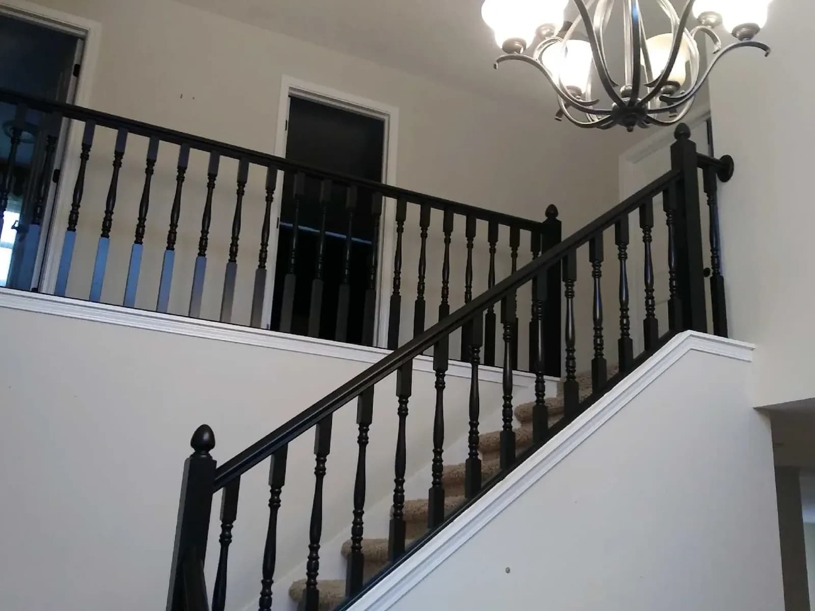 Stair railing and balusters painted black